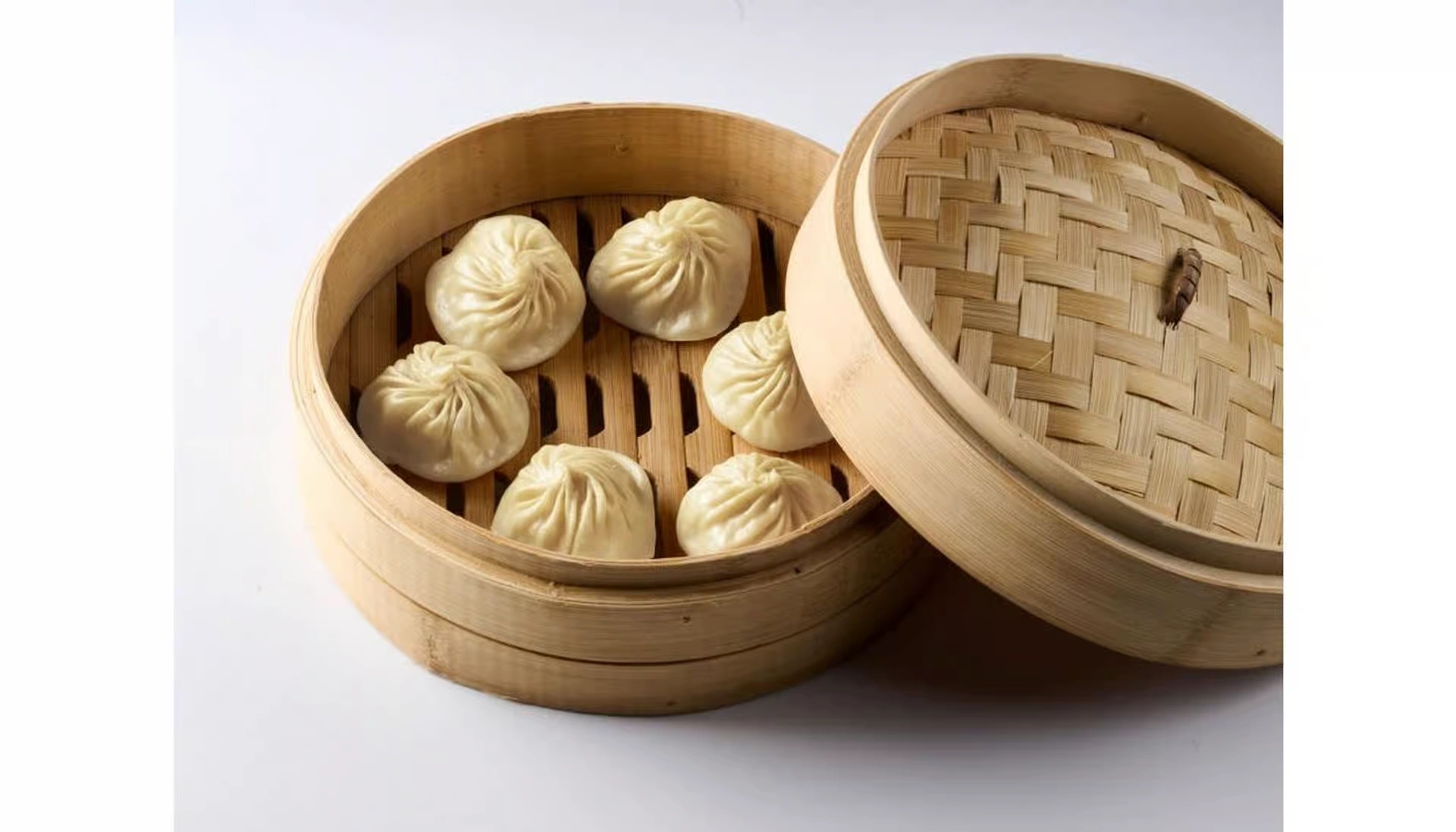 Ugly Dumpling pork soup dumplings in a bamboo steamer basket